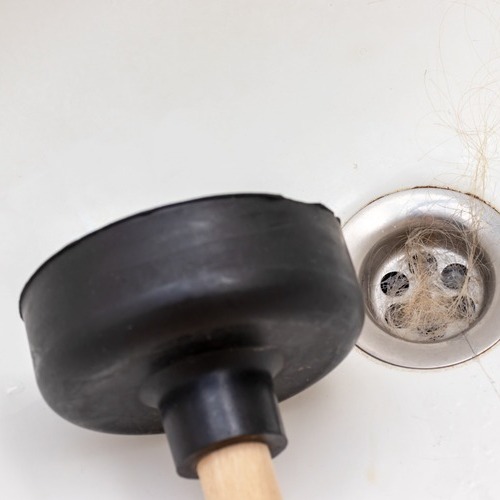 plunger next to a drain