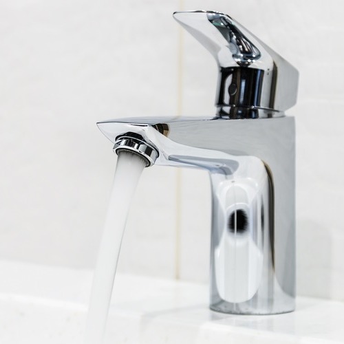 close-up of a flowing water faucet